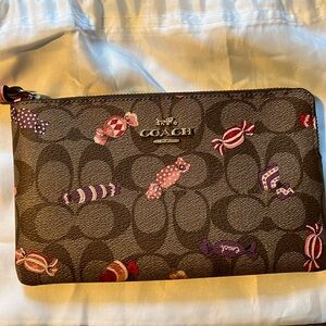 Coach wristlet with candy design.